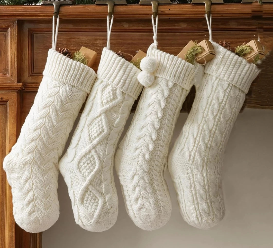 Four white knitted Christmas stockings 
